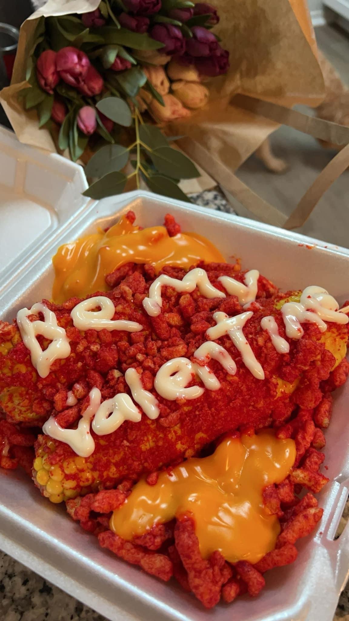 Hot Cheeto elote decorated with a handwritten message